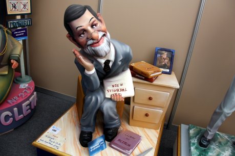 Escena de l'Exposició del Ninot 2012 que mostra Rajoy pensatiu amb llibres sobre crisi i retallades i una foto d'Angela Merkel. FOTO: Soler, José.